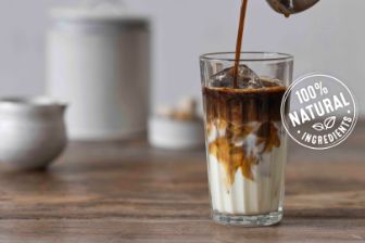 Coffee pouring in milk and 100% natural ingredients logo