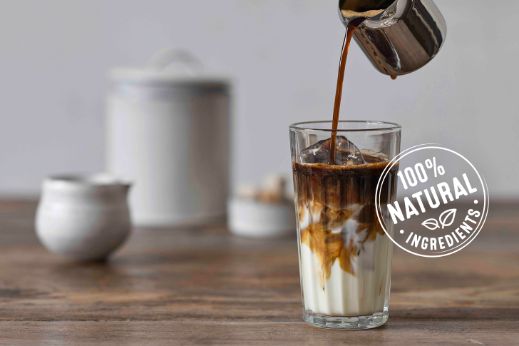 Coffee pouring in milk and 100% natural ingredients logo